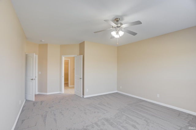 unfurnished room with light colored carpet, baseboards, and ceiling fan