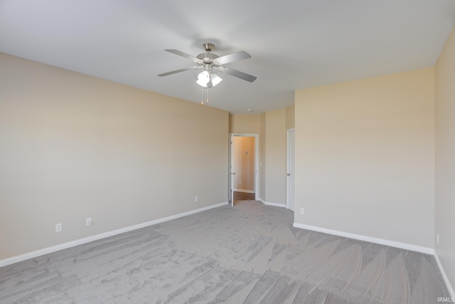 spare room featuring a ceiling fan, baseboards, and carpet floors