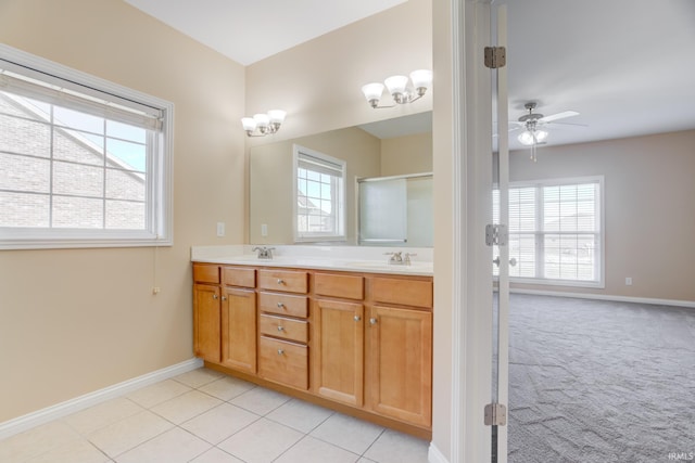 bathroom with double vanity, plenty of natural light, tile patterned floors, and a sink