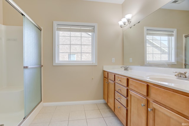 full bath featuring a sink, a healthy amount of sunlight, and tile patterned flooring