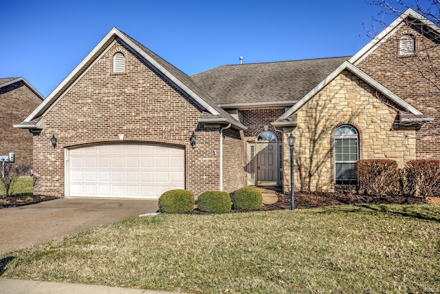 view of front facade with brick siding, concrete driveway, a front yard, a garage, and stone siding