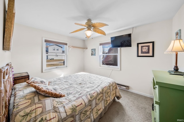 bedroom with carpet flooring, a ceiling fan, baseboards, and a baseboard radiator