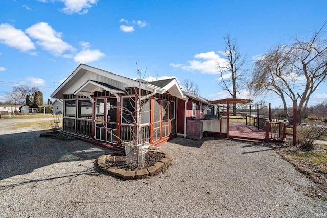 exterior space featuring a deck and a sunroom