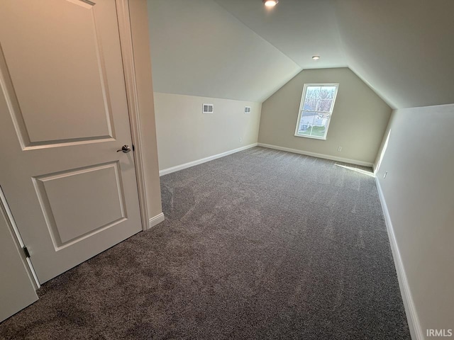 additional living space featuring vaulted ceiling, visible vents, baseboards, and carpet floors