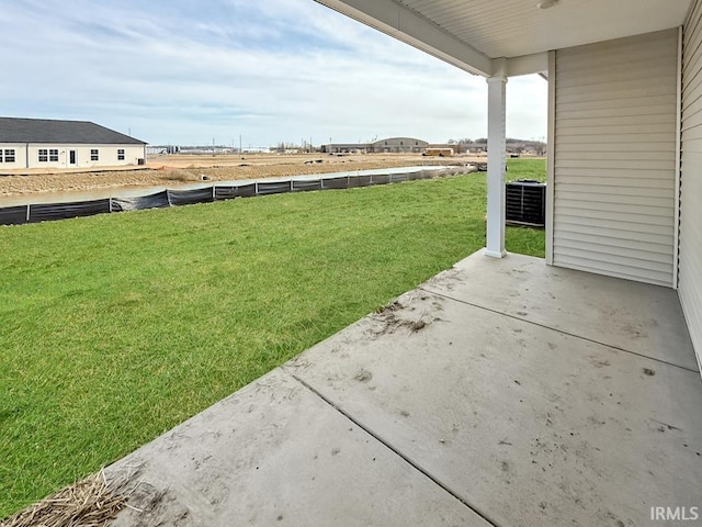 view of yard featuring central air condition unit and a patio