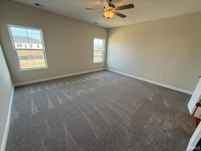 unfurnished room with visible vents, a ceiling fan, baseboards, and carpet floors