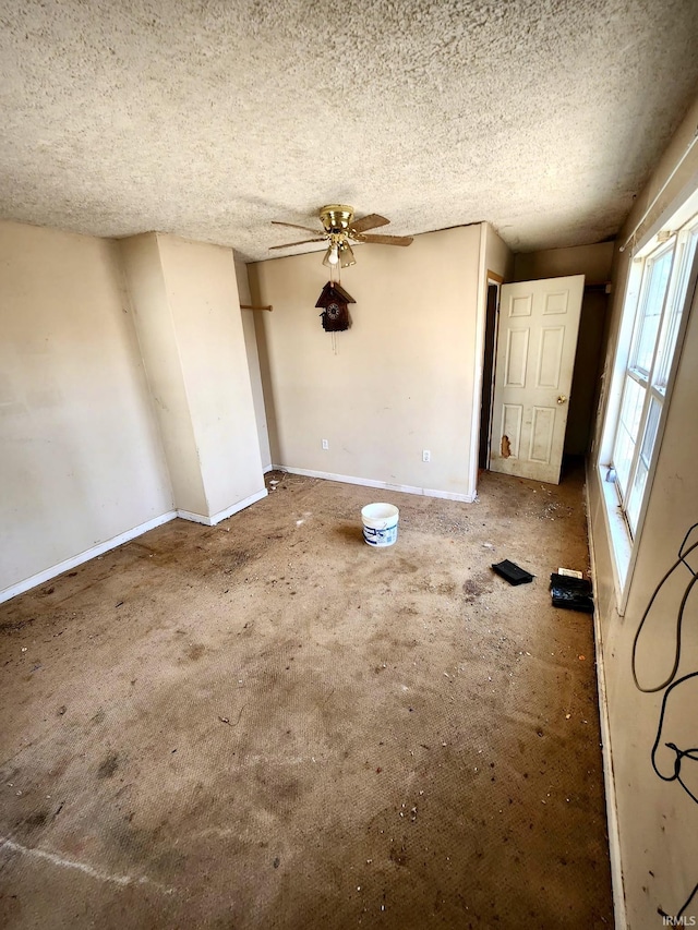 interior space featuring baseboards and a textured ceiling