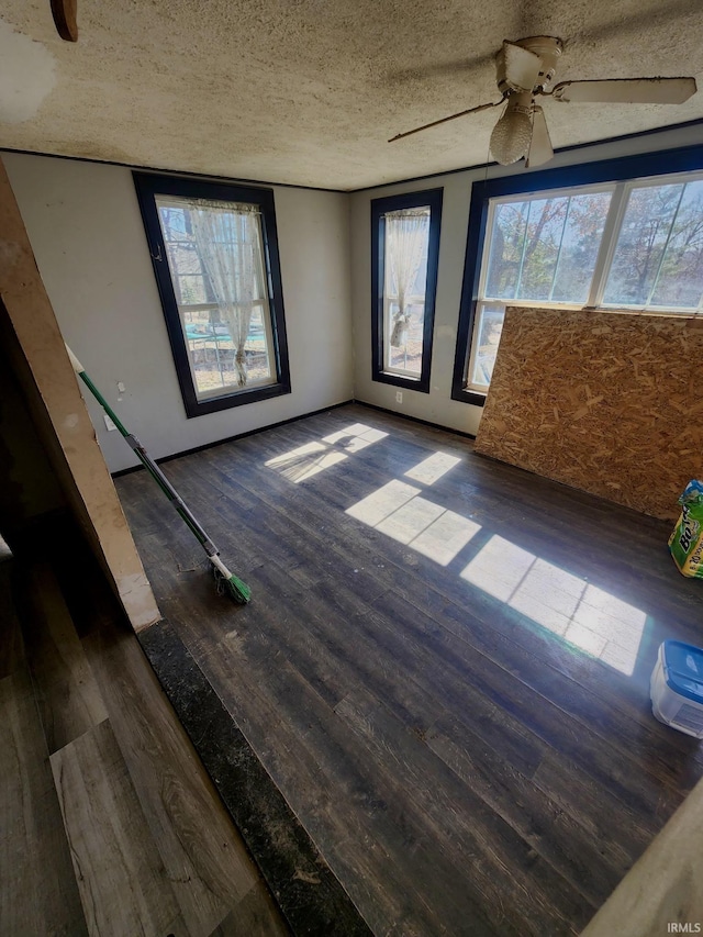 spare room with a textured ceiling and hardwood / wood-style flooring