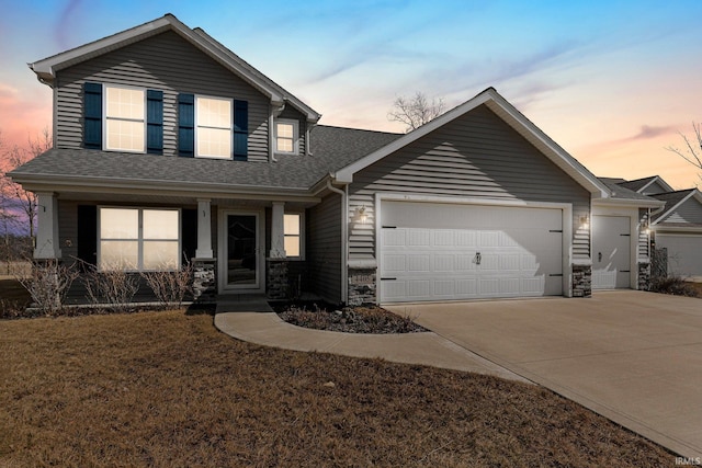 view of front of home featuring driveway, roof with shingles, a porch, stone siding, and a garage