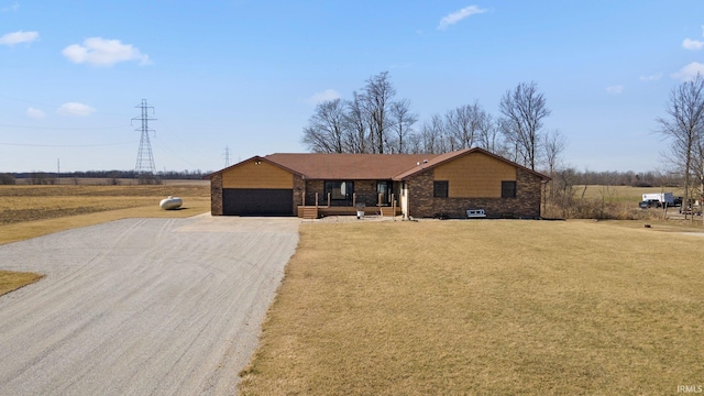 ranch-style home with a front yard, a garage, and driveway