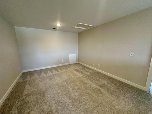 unfurnished room featuring baseboards, visible vents, carpet floors, and attic access