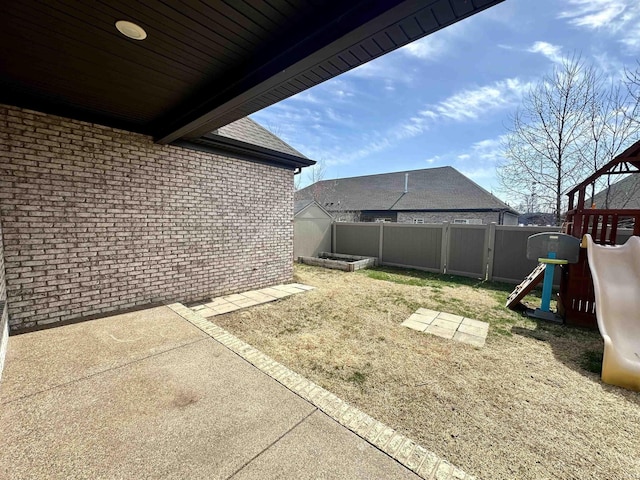 view of yard with a playground and a fenced backyard