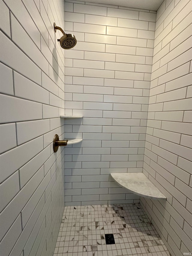 full bathroom featuring tiled shower