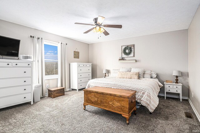 carpeted bedroom featuring baseboards, a ceiling fan, visible vents, and a textured ceiling