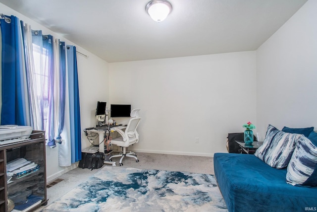 office space with baseboards, carpet floors, and visible vents