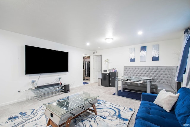 living area featuring light colored carpet and baseboards