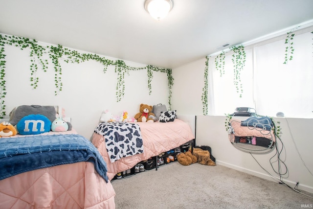 bedroom featuring baseboards and carpet