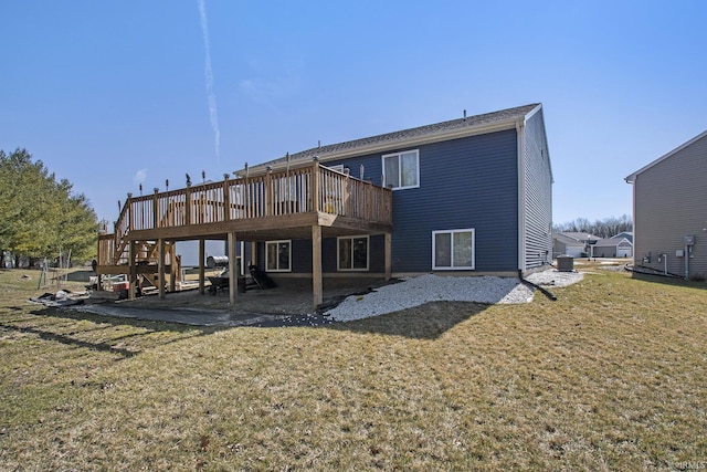 rear view of property with a patio area, a lawn, and a wooden deck