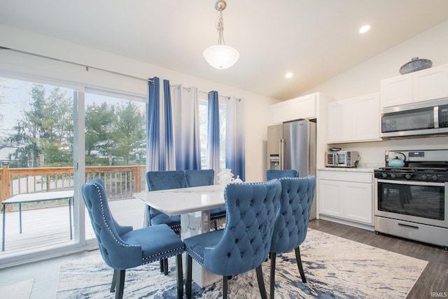 dining area featuring lofted ceiling, recessed lighting, and wood finished floors