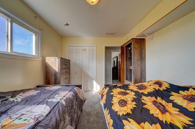 bedroom featuring carpet, visible vents, and a closet