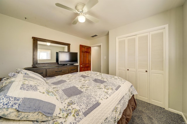 bedroom with a ceiling fan, visible vents, baseboards, a closet, and dark carpet