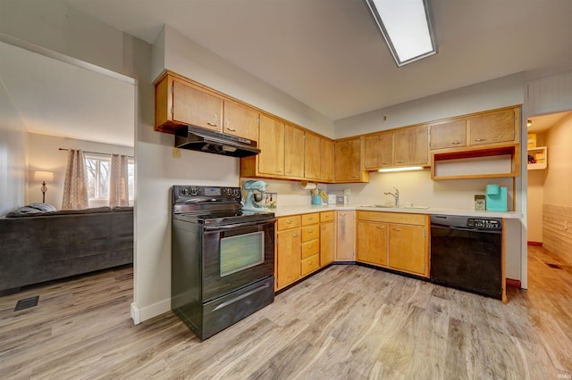 kitchen featuring light wood finished floors, a sink, black appliances, light countertops, and under cabinet range hood