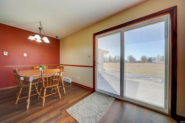 dining room with an inviting chandelier, wood finished floors, baseboards, and baseboard heating