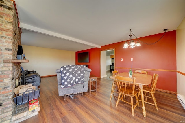 dining room featuring baseboards, beamed ceiling, baseboard heating, an inviting chandelier, and wood finished floors