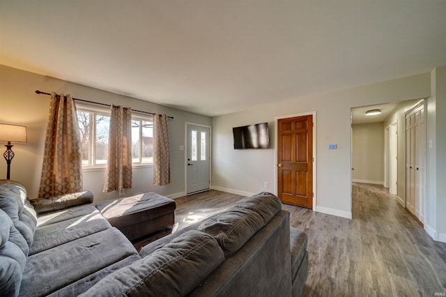 living area featuring baseboards and wood finished floors