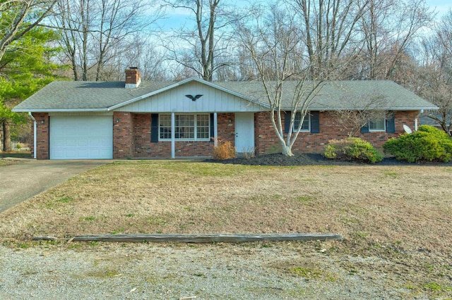 ranch-style home featuring brick siding, concrete driveway, a front yard, a chimney, and an attached garage