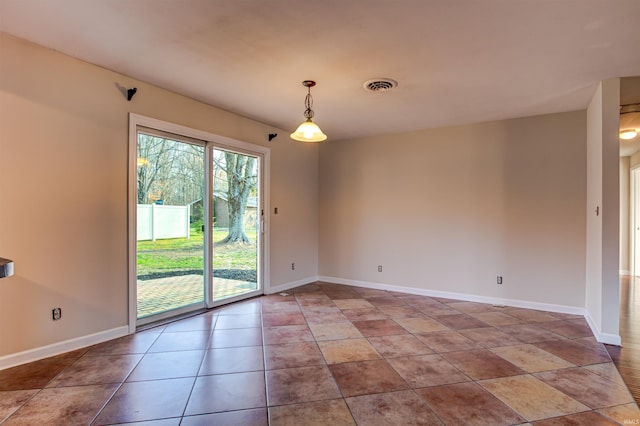 tiled spare room with visible vents and baseboards