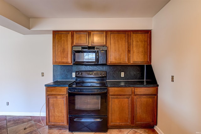 kitchen featuring black appliances, dark countertops, backsplash, brown cabinetry, and baseboards