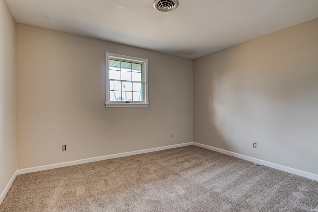 unfurnished room featuring visible vents, baseboards, and carpet flooring