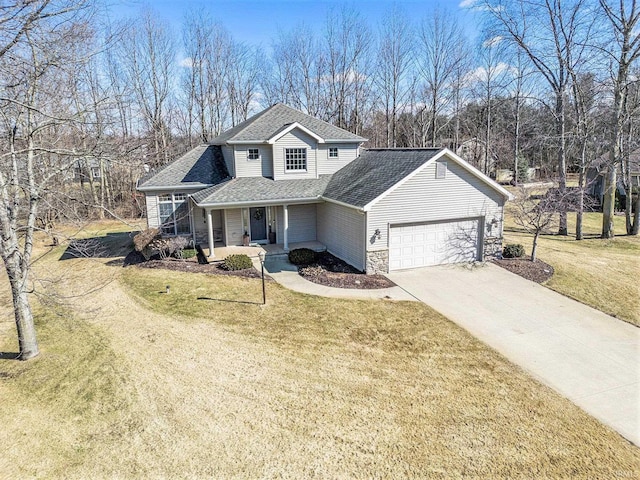 traditional home with a porch, a front lawn, concrete driveway, a garage, and stone siding