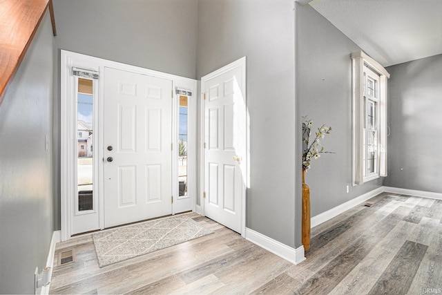 entrance foyer with baseboards and wood finished floors