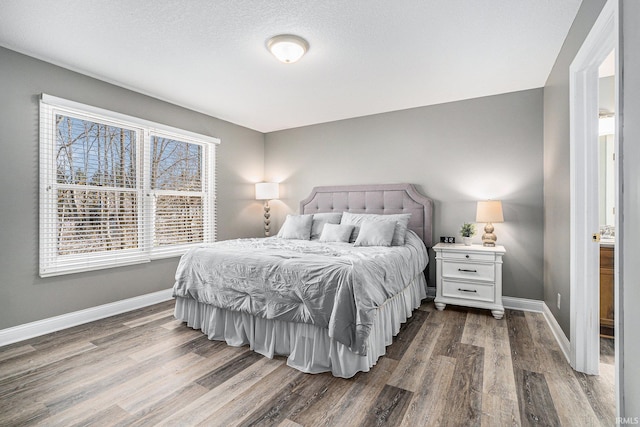 bedroom featuring dark wood-type flooring and baseboards