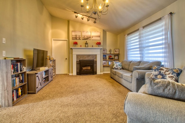 carpeted living room featuring track lighting, an inviting chandelier, a fireplace, and lofted ceiling