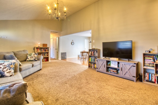 carpeted living area with high vaulted ceiling and an inviting chandelier