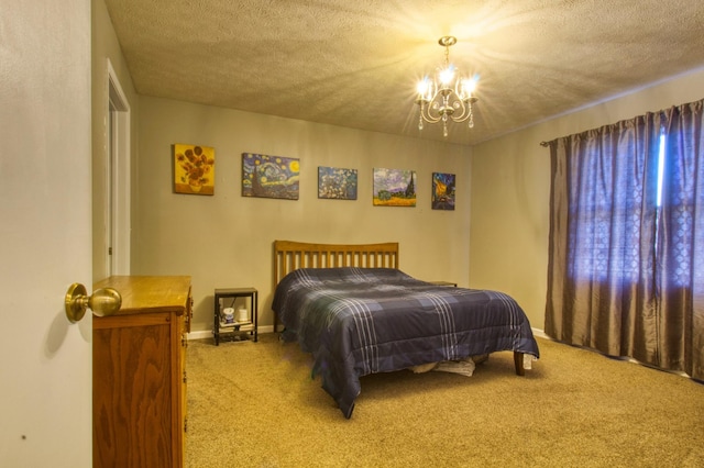 carpeted bedroom featuring a notable chandelier, baseboards, and a textured ceiling