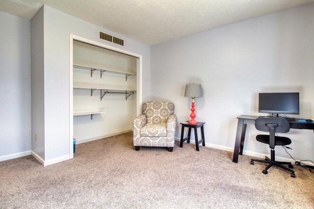 carpeted office with baseboards and visible vents