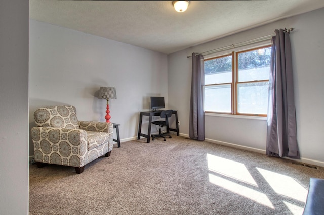 sitting room featuring visible vents, baseboards, a textured ceiling, and carpet flooring