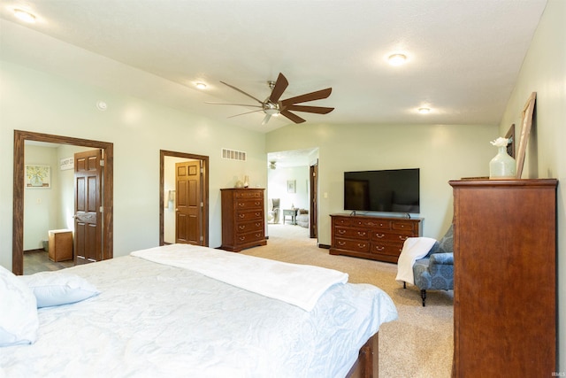 bedroom featuring visible vents, light carpet, lofted ceiling, and ceiling fan