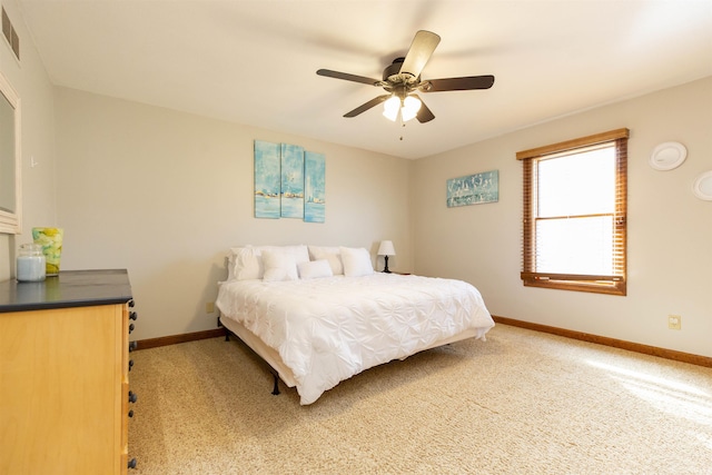 bedroom featuring visible vents, ceiling fan, light colored carpet, and baseboards