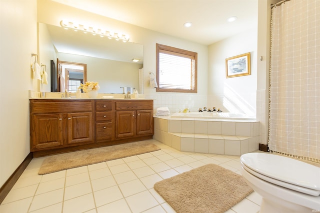 bathroom featuring tile patterned flooring, toilet, a garden tub, and a sink