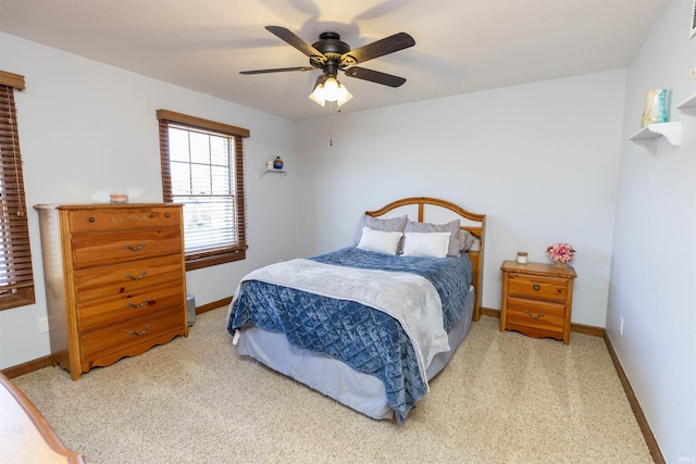 carpeted bedroom with visible vents, ceiling fan, and baseboards