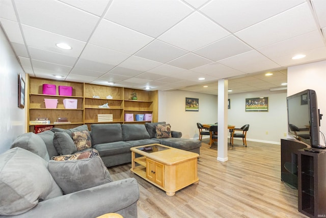 living room featuring built in features, recessed lighting, baseboards, and light wood finished floors