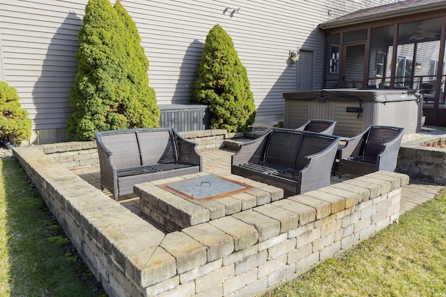 view of patio with a sunroom, outdoor lounge area, and a hot tub