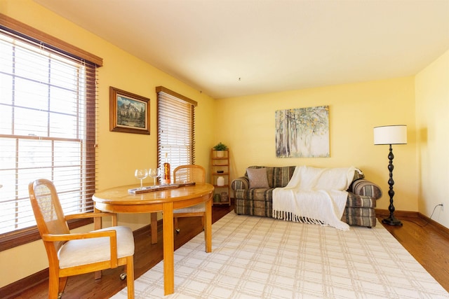 dining room featuring light wood finished floors and baseboards