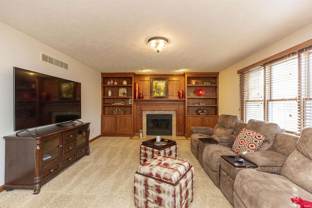 living area with visible vents, a fireplace with flush hearth, light colored carpet, and baseboards