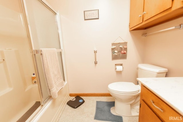 full bathroom with toilet, vanity, baseboards, and shower / bath combination with glass door